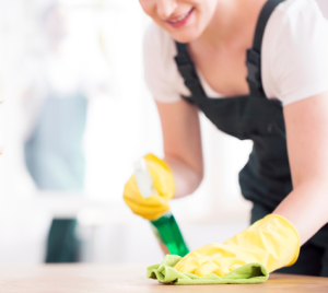 cleaner wiping down a table